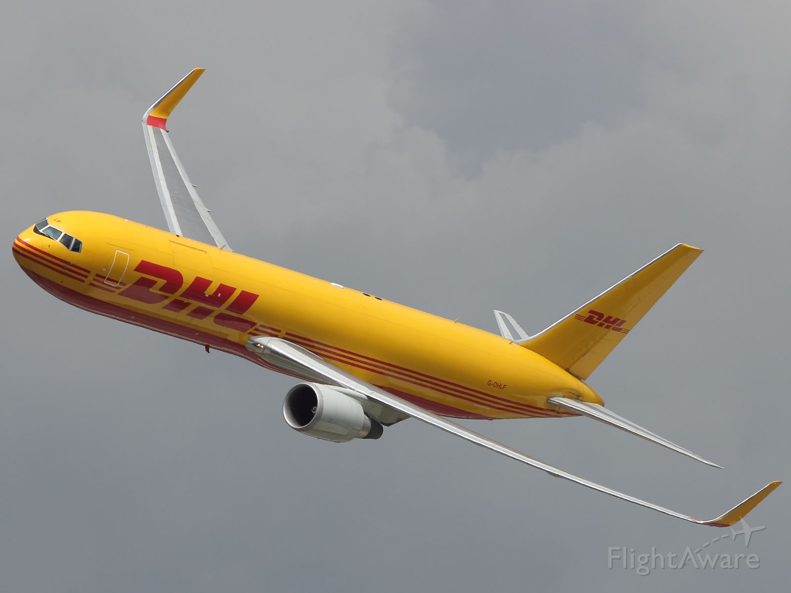 — — - It wasn't all fighters and bombers at RIAT 2012. Here we see a DHL B767-336ER run through an impressive low level flying display. Make a nice change of pace for the pilots, used to hauling cargo around the globe!