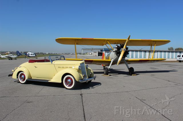N4997V — - On Gary Jet Center FBO ramp with this 1937 Packard and Stearman Bi-plane. 