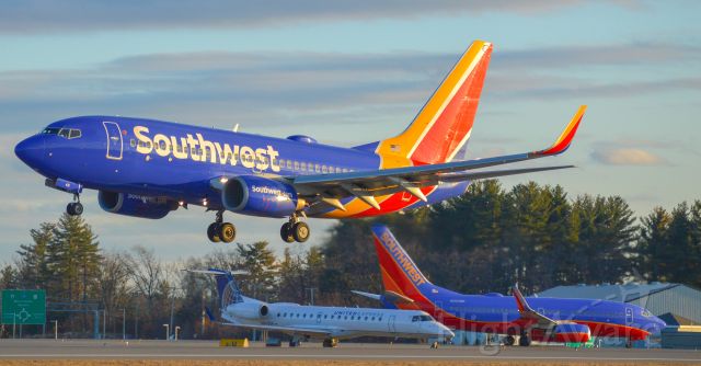 Boeing 737-700 (N431WN) - Southwest landing from BWI while a fellow SW73 awaits to depart for Orlando, and a ERJ awaits departure for Newark