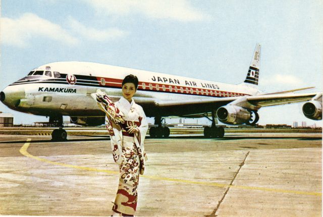 McDonnell Douglas DC-8-60 (JA8006) - This is a Post Card from the early 1970s. I did not photograph this!br /Here is one especially for our Japanese members.br /Posing on the tarmac is a Japan Air lines McDonnell Douglas DC8 along with a Stewardess in her Komono uniform at Toyko Int'l (Haneda) Airport. Kamakura appears under the cockpit windows and is a city south of Tokyo they appear to be honoring. The text on the reverse indicates the approximately 20-hour flight between Tokyo and Paris back then. 