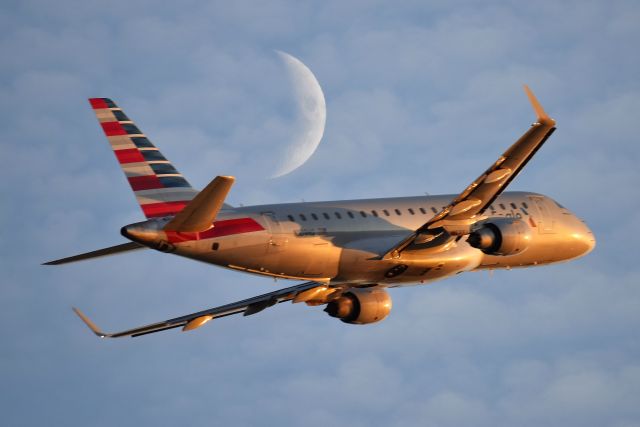Embraer 175 (N109HQ) - American Eagle on 11-19-20 departing 23-L. She is being followed by a moon shadow.