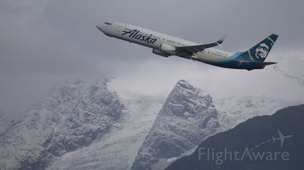 Boeing 737-900 (N270AK) - Climbing out of Juneau to the north on a cloudy day.  The nose gear doors are just closing.