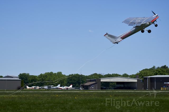 Cessna Commuter (N66637) - This Banner Tow Pilot rapidly pulls up after snagging his banner with the trailing hook.