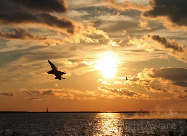McDonnell Douglas FA-18 Hornet (16-1746) - From the archives (3 Sept 2006), this was a rare treat to watch a Blue Angel sunset departure over Lake Erie in Cleveland. US Navy Blue Angel #7 (cn 0103) made a quick trip to NAS Oceana to pick up parts for the #2 aircraft. Impressive view, complete with sunset, sailboats, and seagulls!