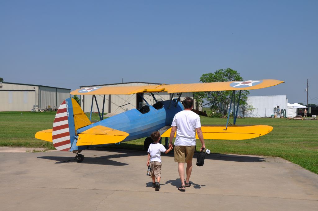 Boeing PT-17 Kaydet — - "Dad, I have PLENTY of 182 time.  How about I log some Stearman time in Mike's plane?"  "No problem bud, lets take her up.  She isn't fast but can take more G's than you and I combined."
