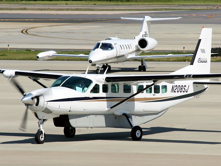 Cessna Caravan (N208SJ) - Cessna Grand Caravan taxiing to parking with a Lear Jet 35 following