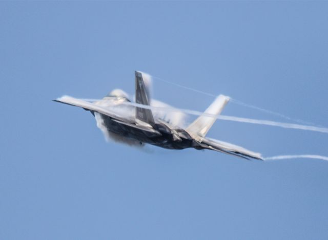 Lockheed F-22 Raptor — - Vapor cloud forming around the F-22 as it activates the afterburners. Thank goodness for the Canon 800mm lens! Questions about this photo can be sent to Info@FlewShots.com