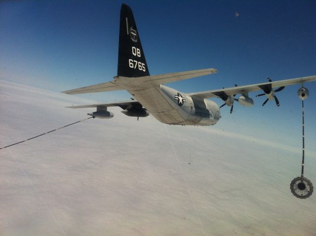 — — - KC-130J refueling an MV-22 Osprey over the Pacific Ocean