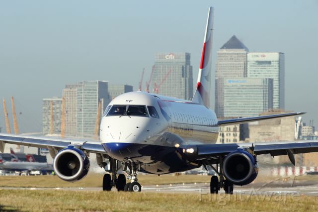 Embraer 170/175 — - An E-170 taxies down the runway at London City Airport, with CBD in background.