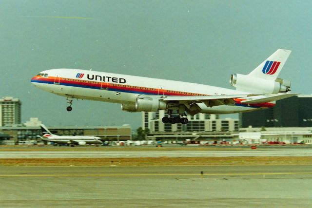 McDonnell Douglas DC-10 (N1852U) - KLAX - Summer 91-93 UAL DC-10-30 arriving 25L - Photo from the Fed Ex parking lot with a ladder assist! This was one neat parking lot to watch airliners - I was never hassled here with ladders up by the fence from 1989 - 1994. I havent been to LAX in years but I bet Id never get away with a ladder by the fence now a days, let alone even park here. delv new to Laker Airlines in May 1980 - last with Fed Ex as N323FE CN: 47811 LN:302