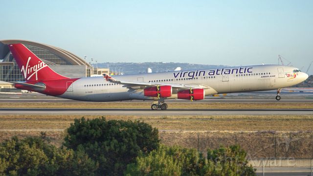 Airbus A340-300 (G-VSUN) - Virgin Atlantic holding a very long flare down 24R at KLAX after a long haul from LHR 