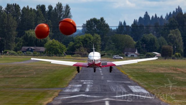 Mooney M-20 Turbo (N9143X) - Looking southeast down runway 15 as a Mooney M20 eases onto the pavement at Harvey Field, Snohomish, Washington, USA