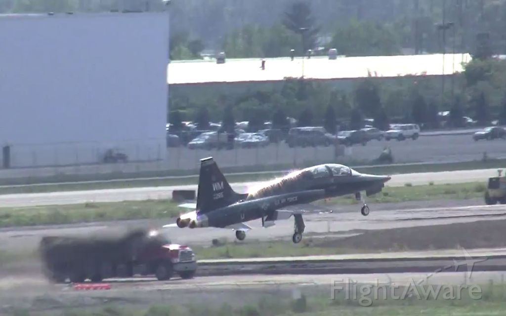 Northrop T-38 Talon (6413265) - A rather shiny FAST11 blazes by the new runway construction.