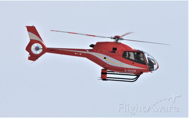 C-FHVM — - C-FHVM Eurocopter EC-120-B survolant le fleuve St-Laurent QC. à Lavaltrie le 06-02-2022 