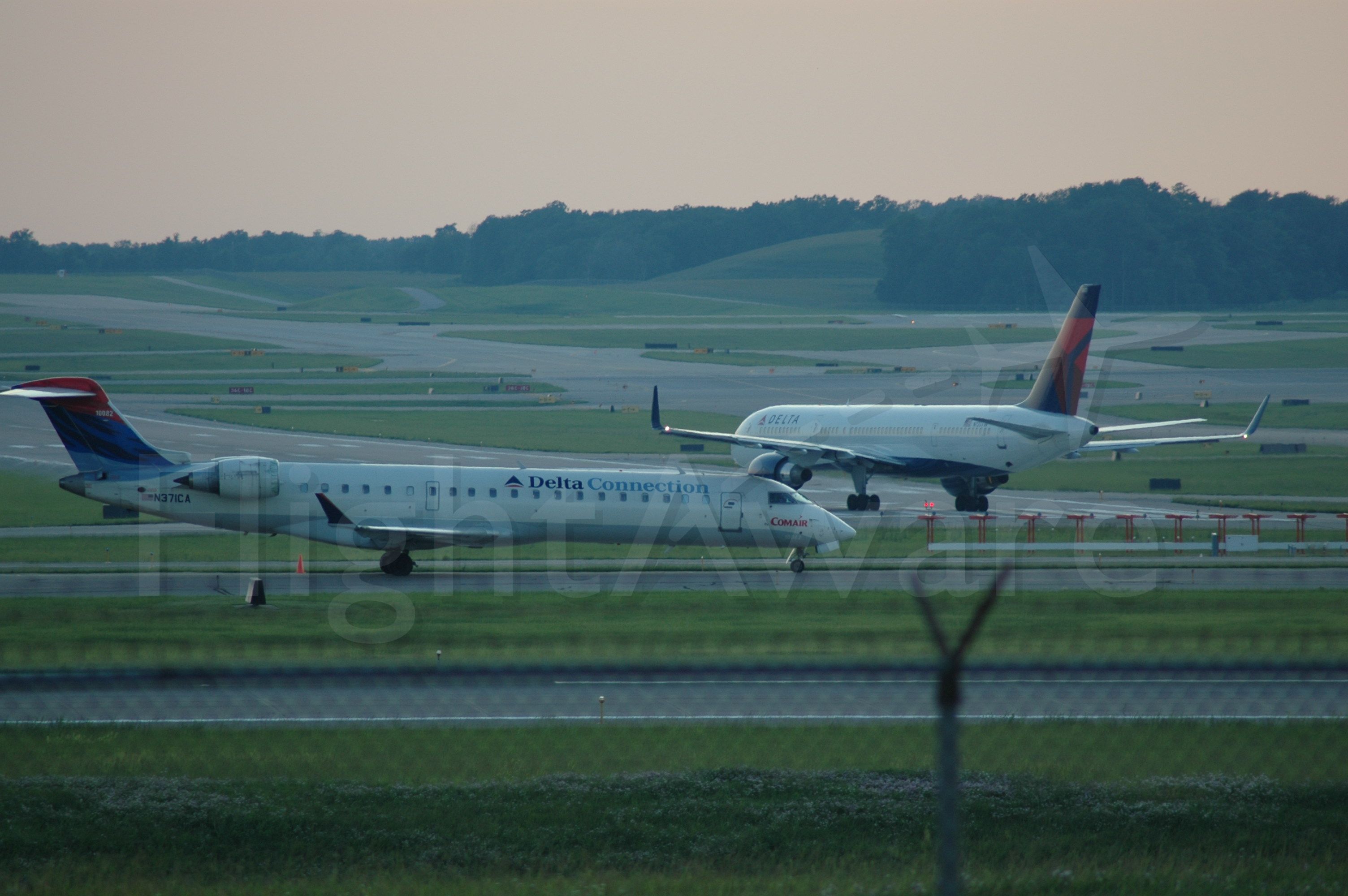 Canadair Regional Jet CRJ-700 (N371CA) - CRJ just landed with a 767 taxing onto 27
