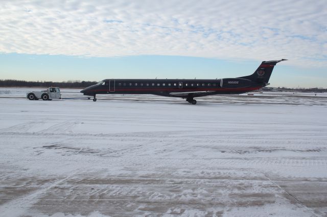 Embraer ERJ-145 (N500DE) - Getting pulled by the Gary Jet Center tug to be readied for takeoff from Gary/Chicago Regional Airport picture was taken 12/20/13.
