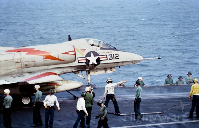 — — - A VA-144 A-4C Skyhawk operating as War Paint 312 (BuNo 149532) armed with Mark 82 Snakeye bombs receives a catapult ready thumbs up for a strike mission launch into North Vietnam from USS Kitty Hawk CVA 63 operating from Yankee Station, Tonkin Gulf, South China Sea in January 1967. 50mm with 2X extender from the 06 observation deck(Vultures Row). 