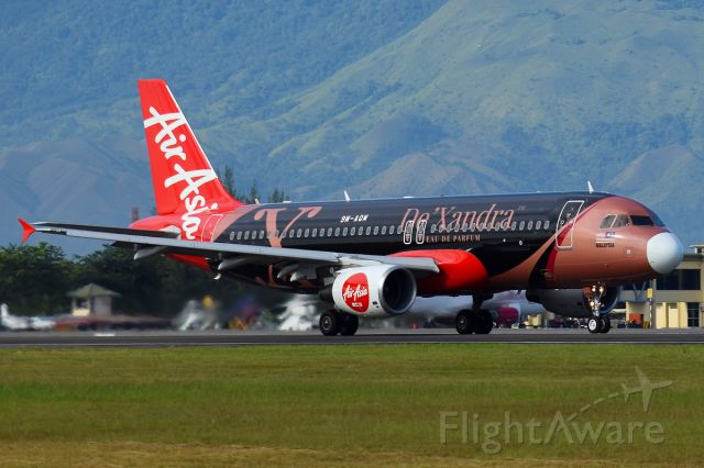 Airbus A320 (9M-AQM) - New Livery of Air Asia DeXandra. taking off with runway 35, with mountain background 