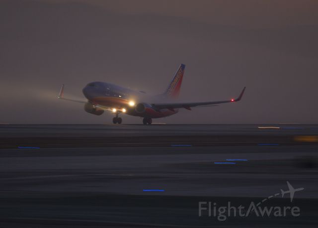 Boeing 737-700 — - Pre-dawn takeoff through ground fog from LAX, Los Angeles, California USA, Runway 24L Sorry, cant see the tail number. 3 January 2014 06:40 AM.