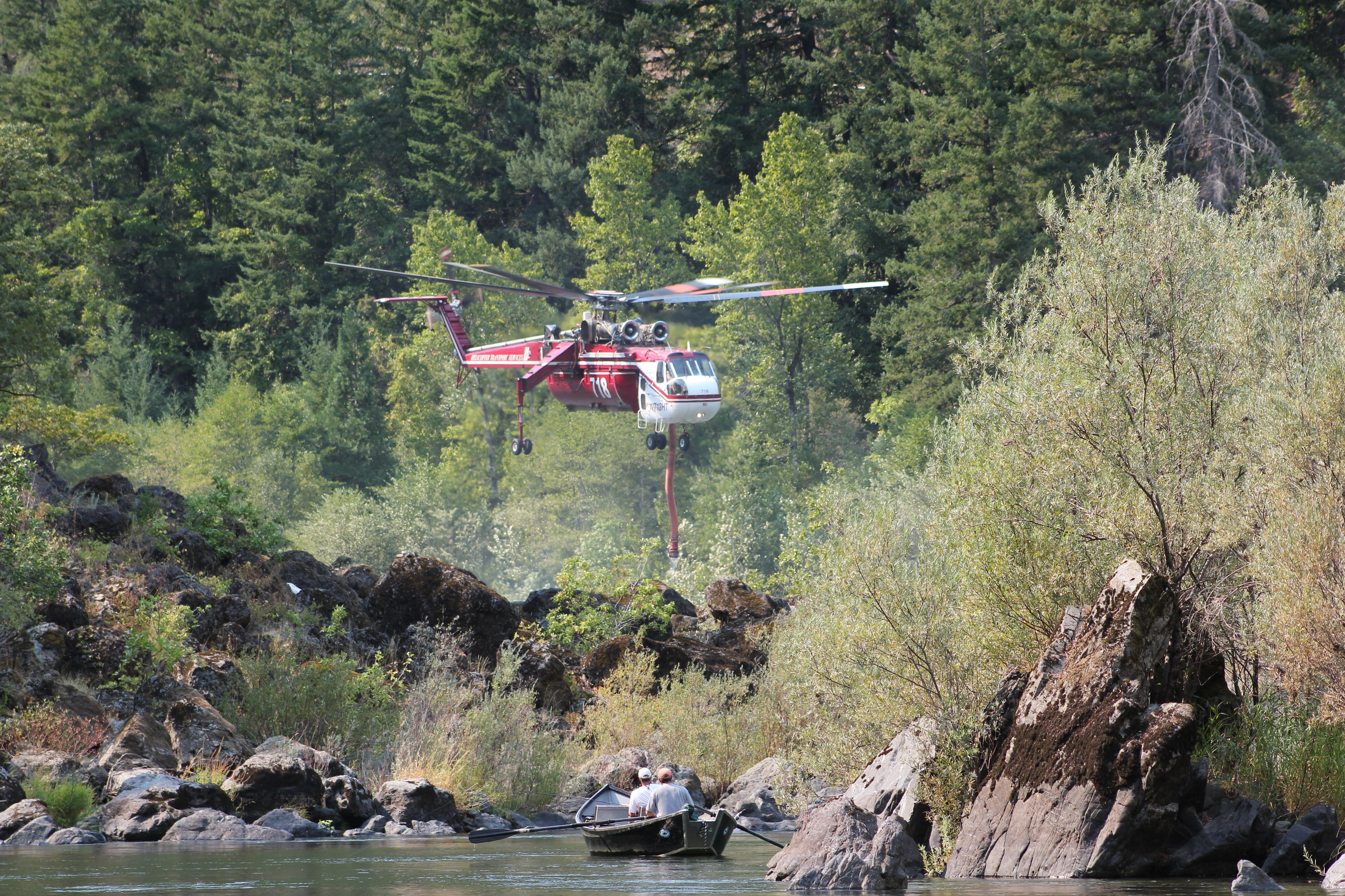 Sikorsky CH-54 Tarhe (N718HT) - Fire Fighting Aircrane Helitanker departing after taking on water in the Rogue River on September 10th 2013. Salmon Float Fishermen in the foreground. This tanker made over 20 runs that day