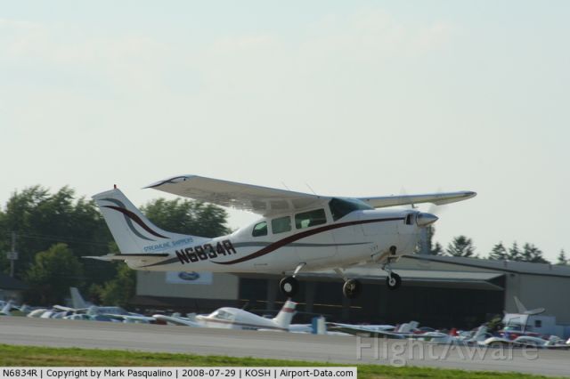 Cessna T210 Turbo Centurion (N6834R) - Departing the Oshkosh air show.