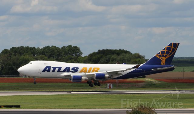 Boeing 747-400 (N415MC) - Atlas Airs Boeing 747-400 about to touch down on Runway 18R @ Huntsville International...Shot with a 70-300mm lens on a Canon T5 from the top of the parking deck...