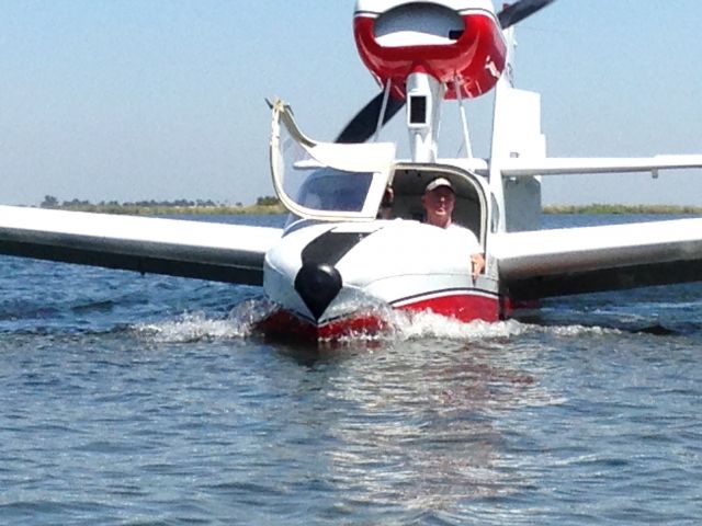 LAKE LA-200 (N7615L) - Lake N7615L water taxiing to beach at "Mildred Island", California delta, near Discovery Bay, California, piloted by owner Duard Slattery, showing new red & white paint job, summer 2014