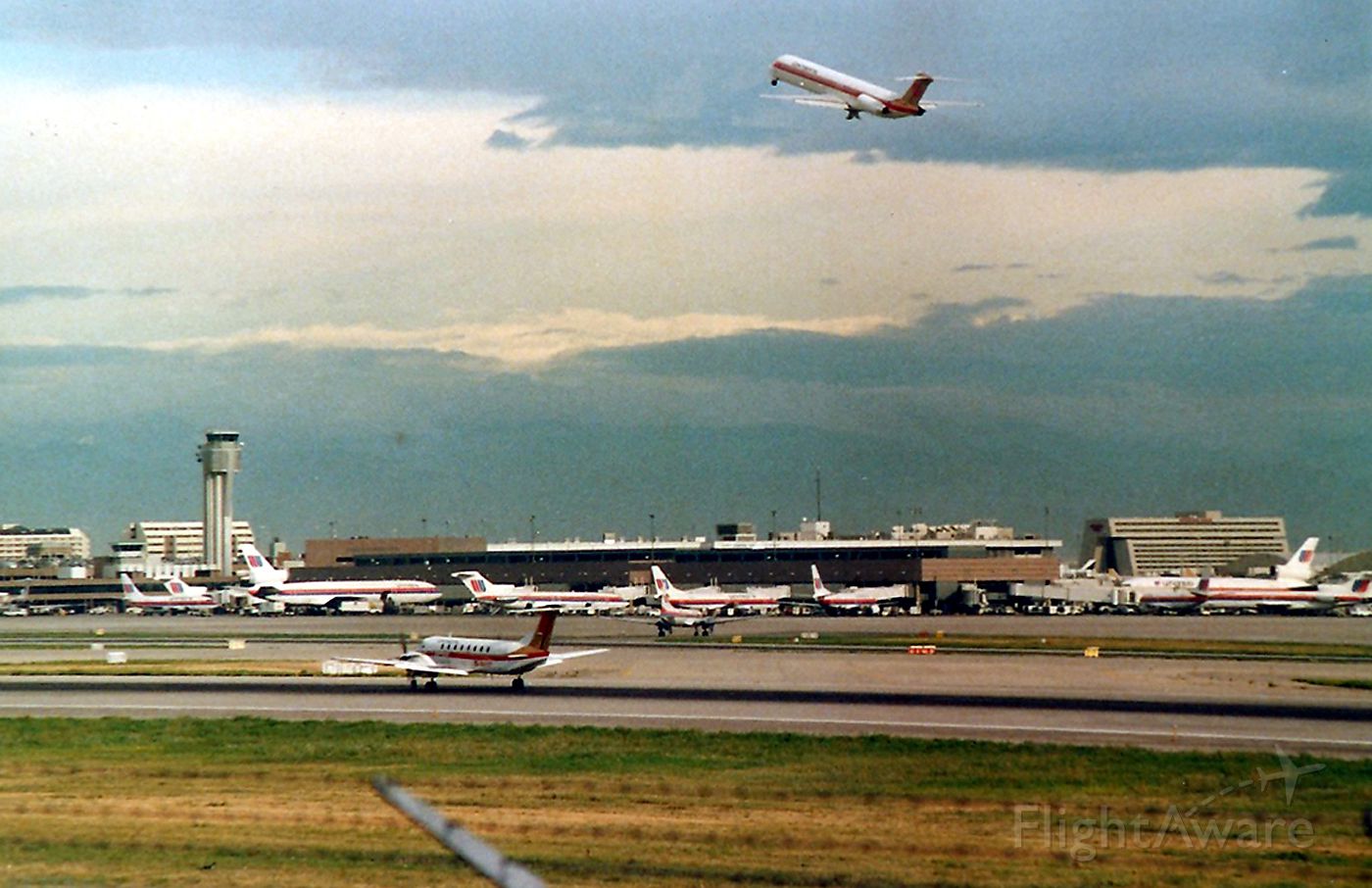 Beechcraft 19 Sport (N32017) - KDEN - Aug 1998 view of Stapleton - Note the MD-80 performing a wheels up go around, as the UAL Convair 580 ( right of the B-1900 middle runway ) The MD-80 was touching down and then immediately lifted as the UAL 580 had not cleared he runway yet - and I don't know why - poss missed a high speed. Anyways, everything just froze on the runways and taxi ways until ATC cleared everybody. I had 3 hours this AM to film and foto at Stapleton, and this was one busy airport - even Aug 1988 standards.