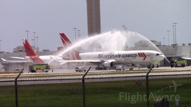 Boeing MD-11 (PH-MCP) - Martinair Cargos last MD-11 receiving a water cannon salute from the Miami International Airports fire rescue before departing for its final flight to the Mojave Air and Space Port (KMHV)s aircraft boneyard to be scrapped.