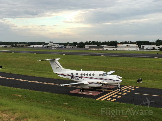 Beechcraft Super King Air 200 (N571TM) - Greenville Jet Center in the background.