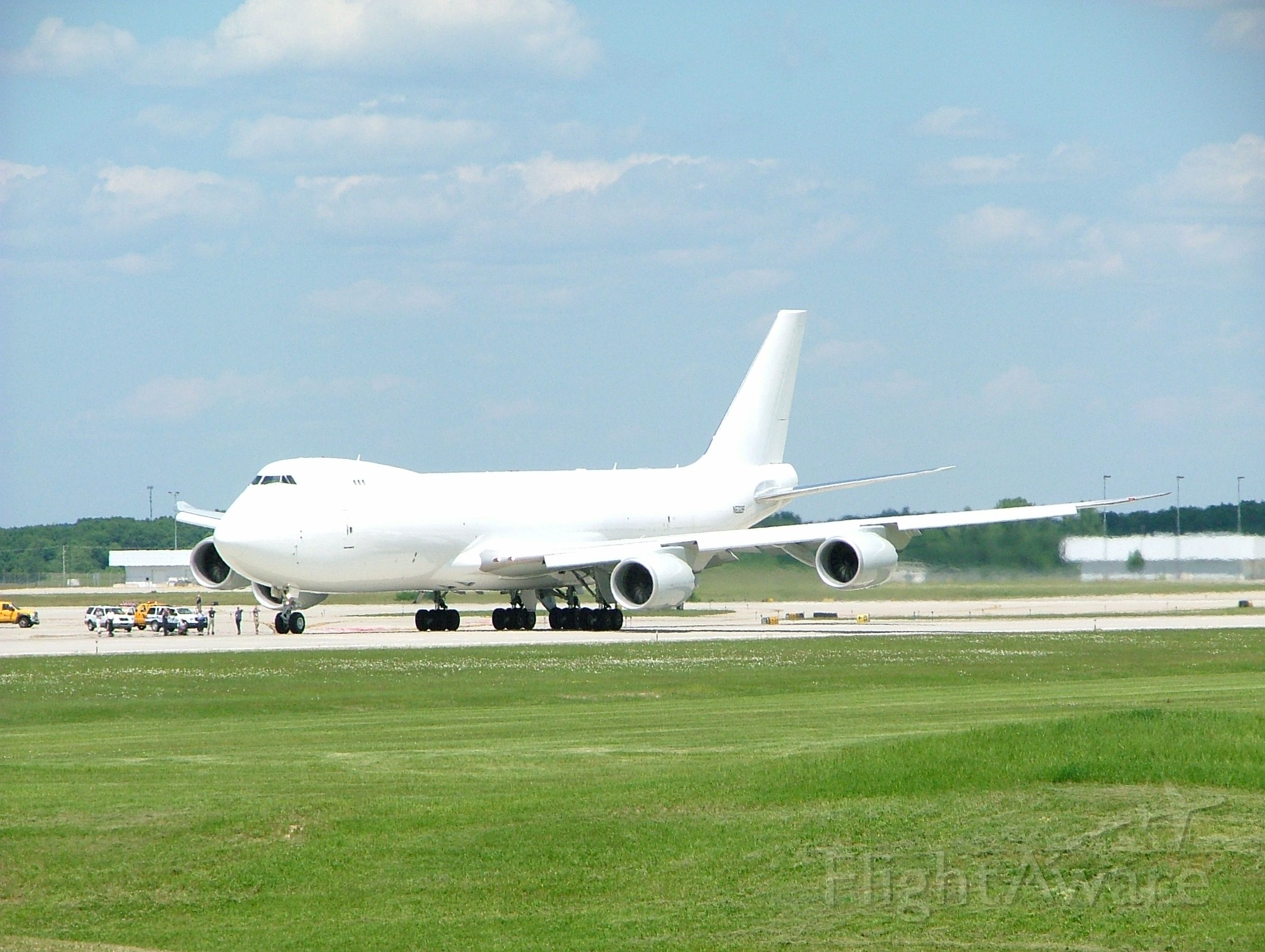 BOEING 747-8 (N6009F) - Rare shot of Boeing 747-8 landing at KGRR. Note airport personnel watching from taxiway.