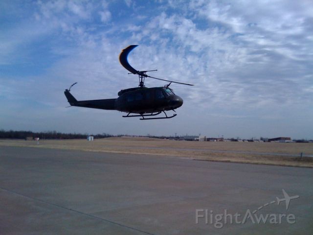 — — - Huey on departure after fueling at United States Aviation located at the Tulsa International Airport.