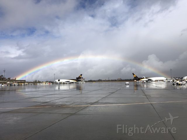 Boeing MD-11 — - Rainbow over two beauties: an MD-11 and a 767. North-facing photo taken December 2020 while working the air ramp.