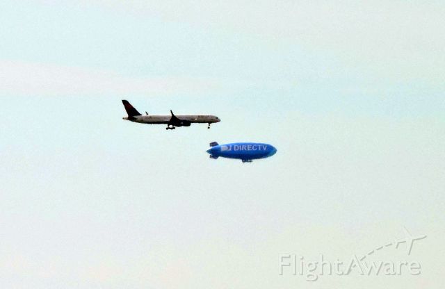 Boeing 757-200 (UNK) - B757 on approach to BOS passing slower traffic-blimp over Fenway Park