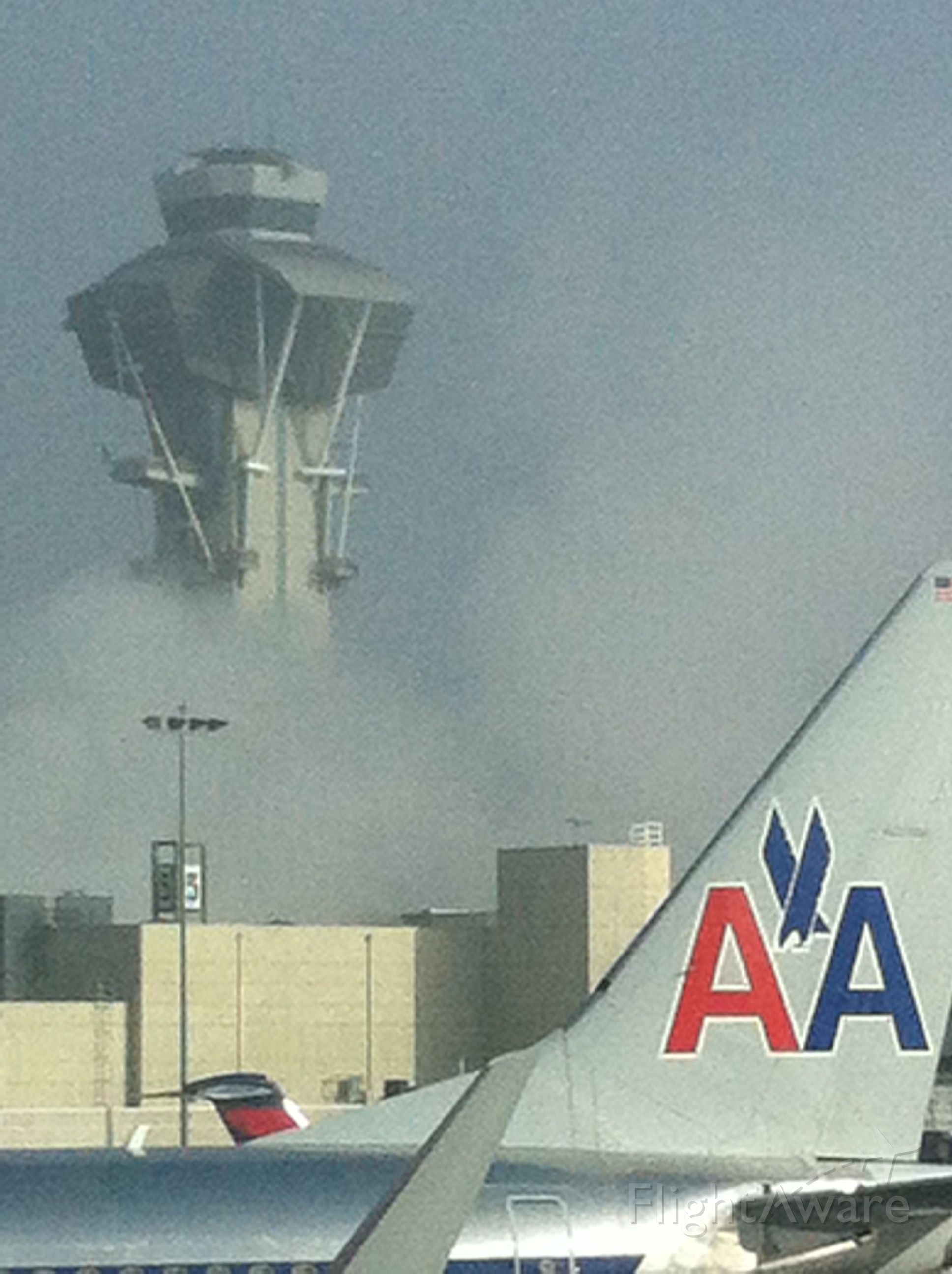 — — - LAX tower emerging from the fog