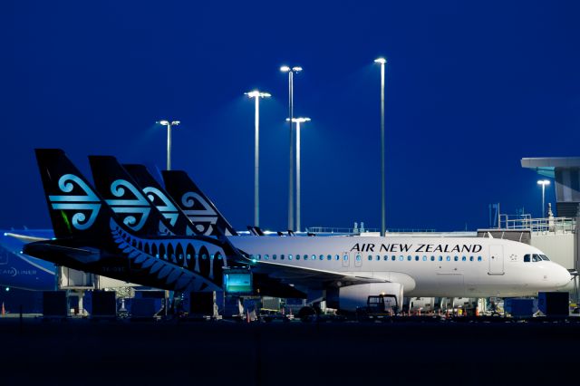 Airbus A320 — - Night time apron action with a lineup of Koru tailed Airbus A320s from Air New Zealand, and a Boeing 788 way in the back from China Southern