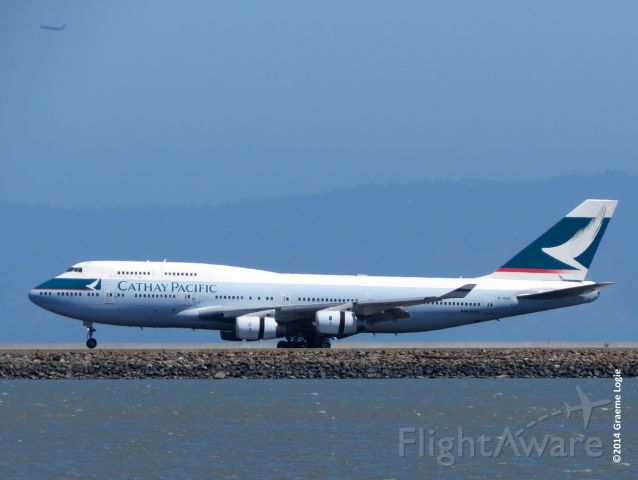 Boeing 747-400 (B-HUG) - From the shoreline parallel to 28L/R at SFO, taken on August 31, 2014.  Flight CX870, the last scheduled passenger carrying Boeing 747 into North America,  by Cathay Pacific Airways. On September 1, 2014, all North American passenger flights by Cathay Pacific will be serviced by Boeing 777-300ERs.  br /br /Note the Southwest Airlines 737 taking off from OAK in the upper left corner.