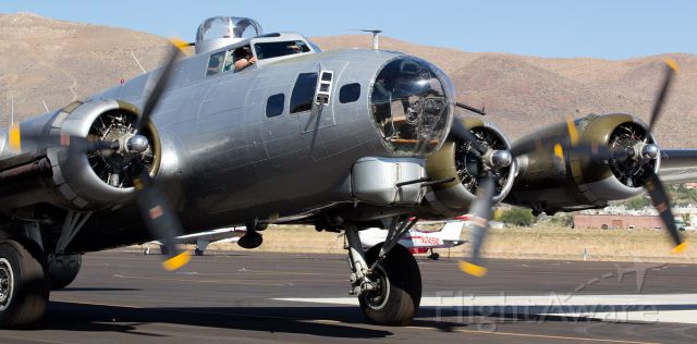 N5017N — - The Experimental Aircraft Association (EAA) Aviation Foundations "Aluminum Overcast" (N5017N, formerly 44-85740), a B-17G, taxies to the ramp at Carson City Airport (KCXP) earlier today. br /This WWII-era bomber (44-85740 came off the production line too late to see actual use in the war) is wonderfully maintained and presented by the EAA. It was a privilege to capture clicks of this beautiful, and rare, military metal classic warbird.  There are less than one dozen B17s still flying.br /* Note the pilot looking to see if I am too close to his aircraft as he swings it around to park.  (I wasnt; I was using a zoom lens to get this close-in shot.)