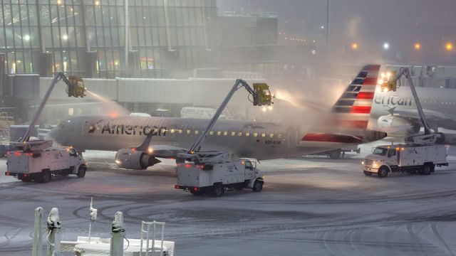 Embraer ERJ-190 (N954UW) - Deicing in full swing as the first snow of the season arrives to Boston