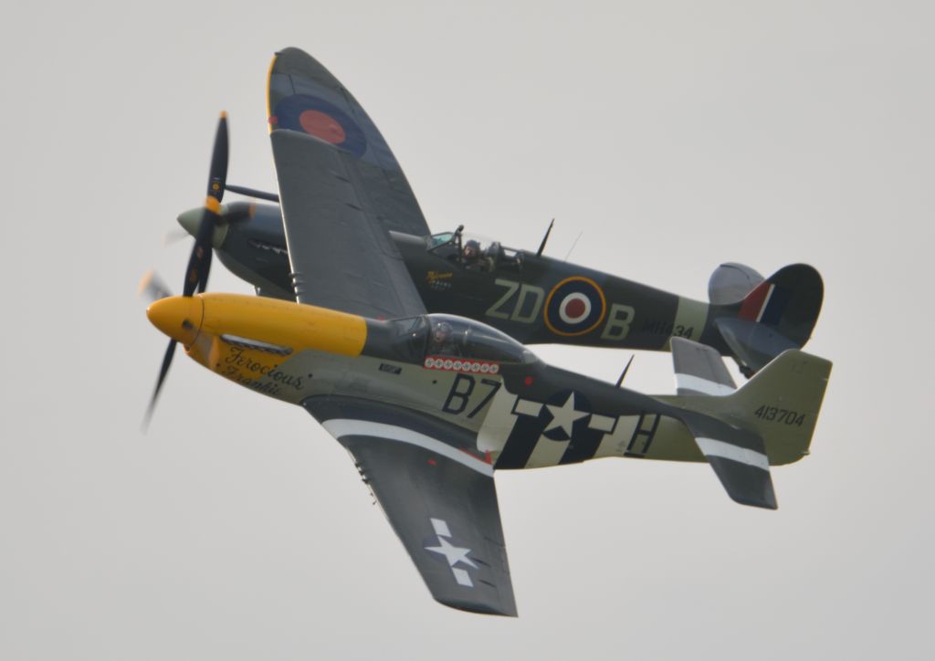MULTIPLE — - P51D Ferocious Frankie and Spitfire Mk9 MH434 performing at Goodwood on 11 Sepetmber 2015