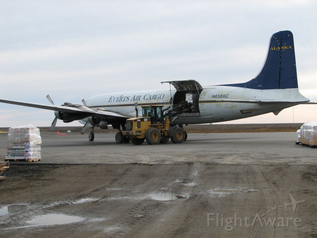 Douglas DC-6 (N6586C) - Unloading at Barrow, Alaska; appears to be mostly cases of soft drinks!