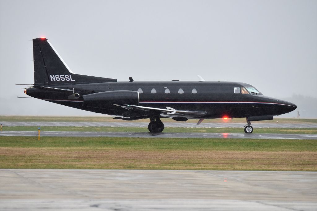 North American Sabreliner (N65SL) - In the rain, that's why the photo is grainy