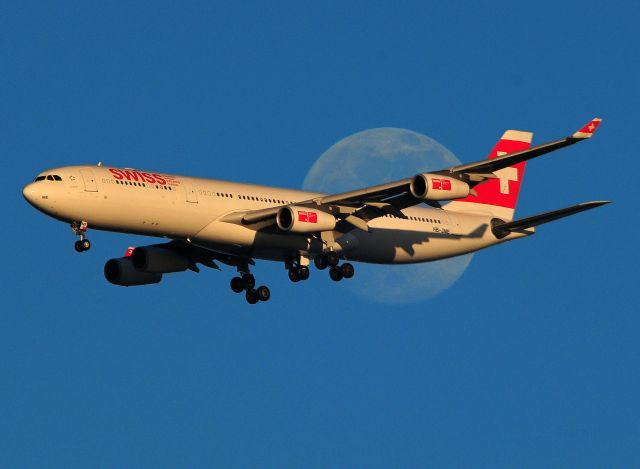 HB-JME — - Swiss Air on approach to 28L crosses a full moon rise.