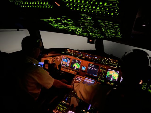 Boeing 777-200 (N702DN) - Night IFR cockpit photo during descent into Sydney, Australia