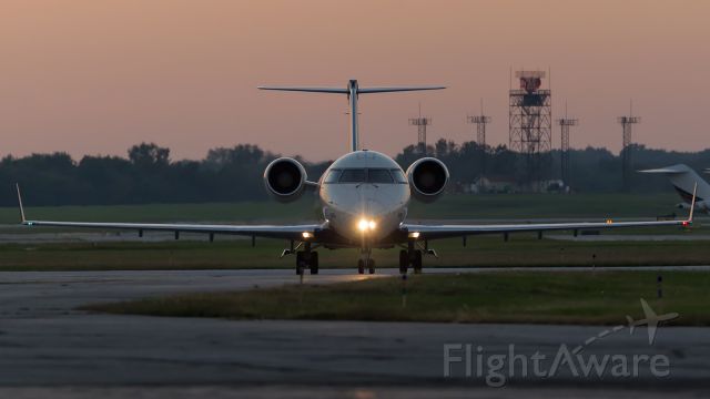 Canadair Regional Jet CRJ-200 (N8884E) - A CRJ-200 taxis toward the gates as the last bit of light fades away.