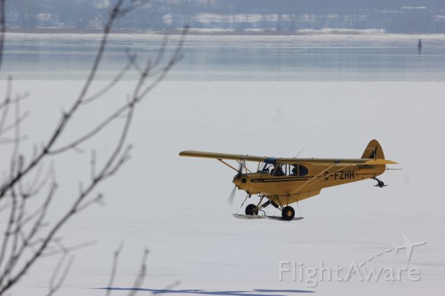 Piper L-21 Super Cub (C-FZHH) - C-FZHH Piper PA-18-135 Super Cub en vol au dessus du Fleuve St-Laurent QC.à Lavaltrie le 28-02-2021 à 12:40.