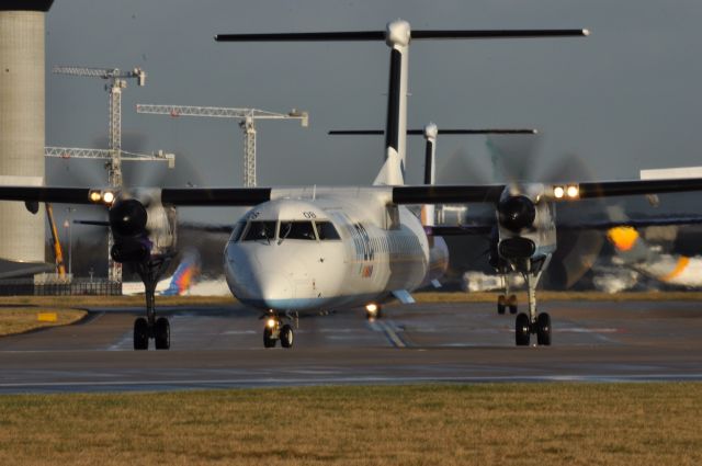 G-ECOB — - Two Dash 8s heading to runway 23L at Manchester . Southside . 