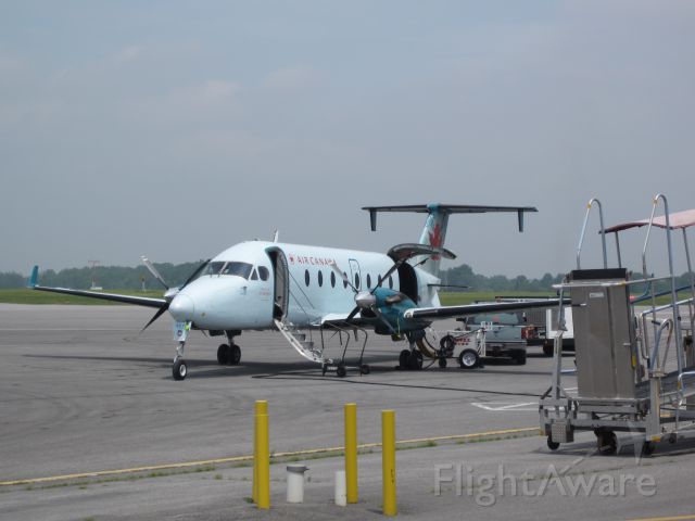 Beechcraft 1900 (C-GORA) - Ready for passengers to disembark. Note the quickness of the ground crew in attaching the different ground units.