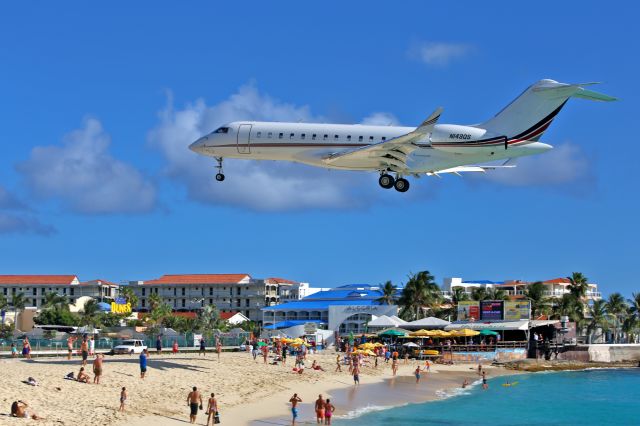 Bombardier Global Express (N143QS) - Landing above MahoBeach. See from the Great Bay Beach hotel.
