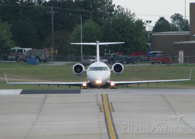 Canadair Regional Jet CRJ-200 (N451CA) - Holding short of 14 waiting on landing traffic at the Shreveport Regional airport.